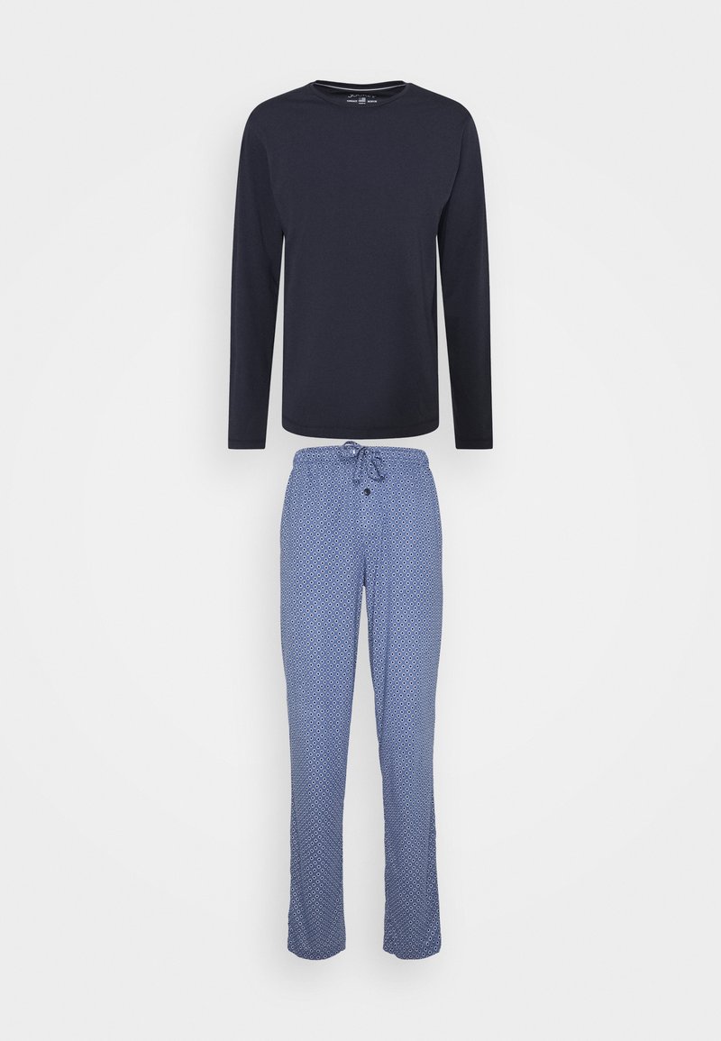 Camisa de manga larga navy sobre pantalones de pijama azul con patrón, con cintura elástica y botón, que presentan diseños geométricos en tonos más claros.