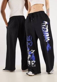 YOURTURN - UNISEX - Tracksuit bottoms - black Thumbnail Image 1