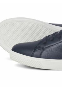 Navy leather sneakers with a white rubber sole, featuring a textured grip pattern and matching laces. Rounded toe design with subtle seam detailing.