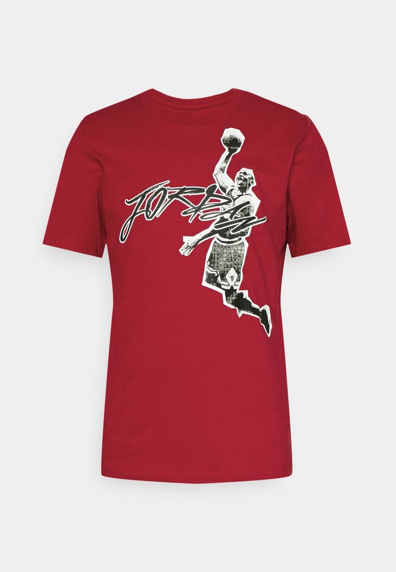 Red cotton t-shirt featuring a black and white graphic of a dunking player, with "JORDAN" text integrated into the design. Short sleeves.