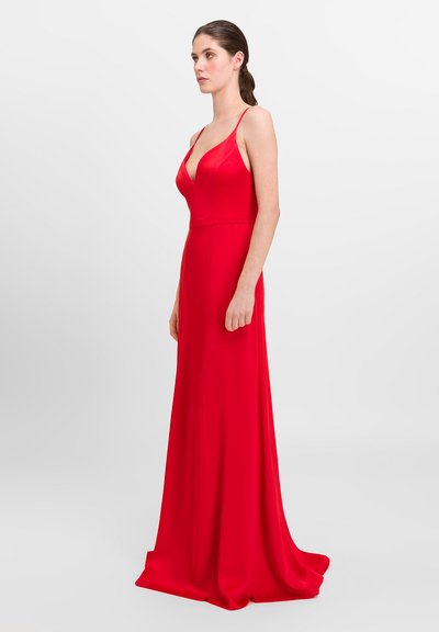 Red, floor-length dress with thin straps and a deep V-neckline. Made from smooth fabric, it exhibits a form-fitting silhouette.