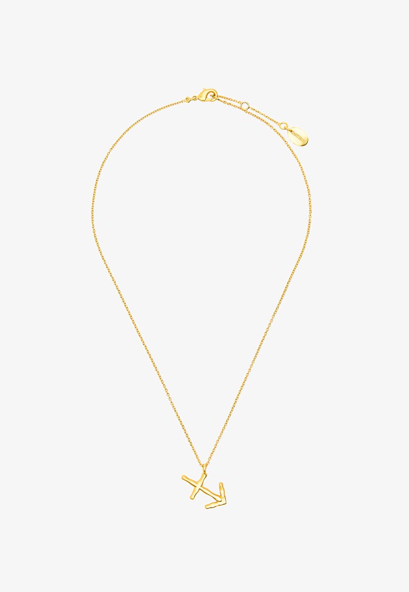 Złoty łańcuszek naszyjnik o minimalistycznym designie z abstrakcyjnym wisiorkiem w kształcie litery. Łańcuszek zawiera zapięcie typu lobster oraz regulowaną długość.