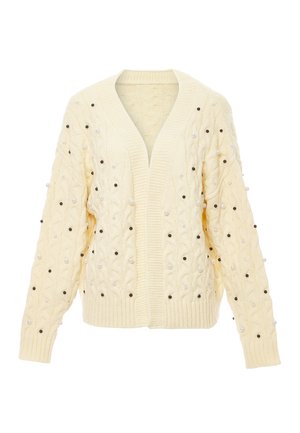 Creme kabelstrikket cardigan med V-udskæring, chunky ribbestrikket kant og dekorerende perler og sorte perler jævnt fordelt over stoffet.