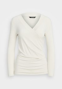Long-sleeve wrap top in off-white, featuring a V-neck, soft fabric, ruched detailing at the waist, and fitted silhouette.