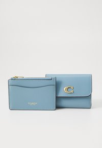 Light blue leather wallet set, featuring a card holder with a zip pocket and a fold-over wallet with a gold accent.