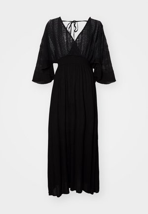 Black maxi dress with a deep V-neck, lace bodice, flutter sleeves, and a cinched waist, featuring a flowy skirt and tie-back design.
