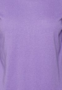 Purple knit sweater with a smooth, fine texture. Features a round neckline and long sleeves. Simple, solid color with no visible patterns or accents.