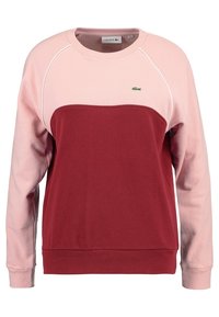 Bordeaux- und hellrosa Sweatshirt mit gerippten Bündchen. Verfügt über ein Lacoste-Logo und ein zweifarbliches Design mit langen Ärmeln und einem runden Ausschnitt.