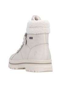 Botte en cuir beige mi-montante avec un col en fourrure blanche, surface texturée et semelle en caoutchouc. Dispose d'une fermeture éclair sur le côté et de lacets pour l'ajustement.