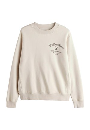 Gaiši bēša džemperis ar ribotu apkakli un aprocēm, priekšpusē tumši brūnā krāsā uzraksts "Yellowstone Dutton Ranch".