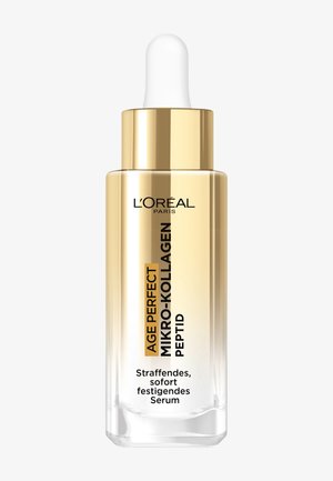 Transparant glazen druppelflesje met een gouden hals en dop, gevuld met een doorschijnend serum. Voorzien van merk- en producttekst in zwart en goud.