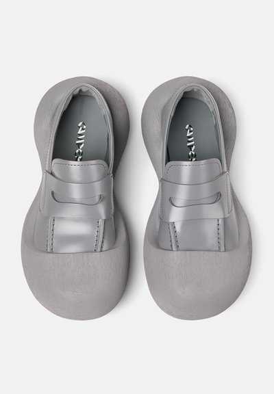 Gray shoes with a smooth leather upper and textured rubber sole. Features a decorative band across the topline and subtle stitching details.