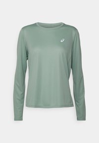 Helles grünes, langärmliges Sportshirt aus glattem, feuchtigkeitsableitendem Material; mit einem kleinen Logo auf der Brust.