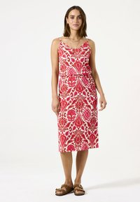 Vestido maxi con escote en V y tirantes de espagueti ajustables. Hecho de tela con estampado en rosa y blanco con diseños florales.