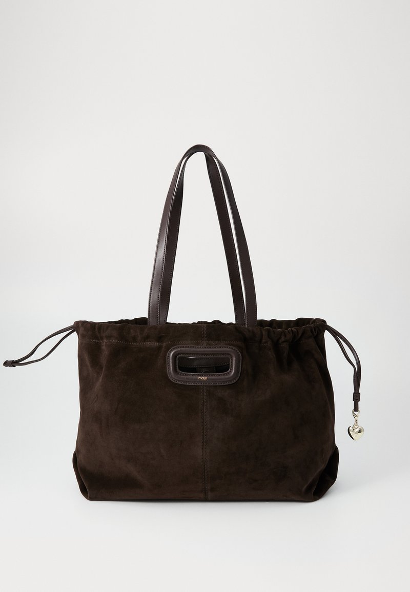 Brown suede tote bag with a gathered top, leather handles, a rectangular clasp, and a small heart-shaped charm on the side.