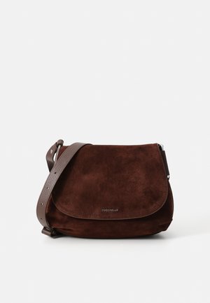 Brown suede shoulder bag with a textured finish, featuring a flap closure and a detachable leather strap. Logo embossed on the front.
