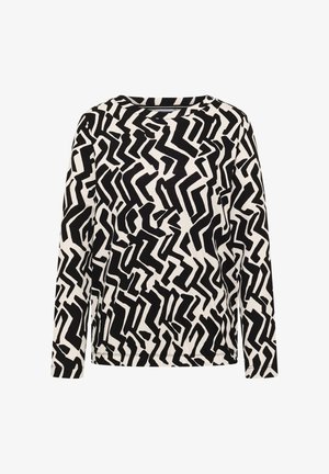 T-shirt à manches longues en tissu blanc avec un audacieux motif en zigzag noir. Encolure ras du cou et coupe décontractée avec ourlet droit.