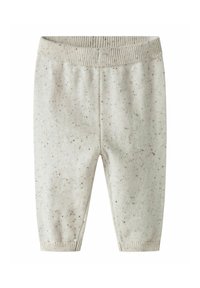 Pantalons bébé tricotés couleur crème avec des taches marron, taille côtelée et poignets côtelés.