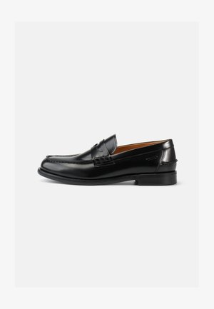 Schwarze Lederloafer mit glatter Oberfläche, abgerundeter Spitze und dekorativer Naht auf dem Schaft. Niedriger Absatz, mit klassischem Profil.