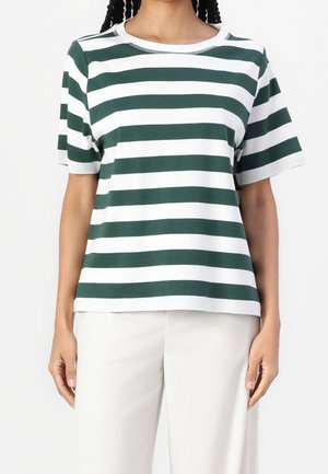 Person wearing a green and white horizontal striped short-sleeve shirt paired with white pants, standing against a plain background.