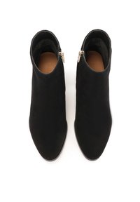 Stivaletti in suede neri alla caviglia con punta affusolata, chiusure a zip sui lati e una texture liscia. Suola robusta con accenti minimi.