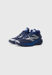 Pair of navy blue athletic sneakers with silver accents, mesh fabric, cushioned soles, and New Balance logo on tongue and sides.