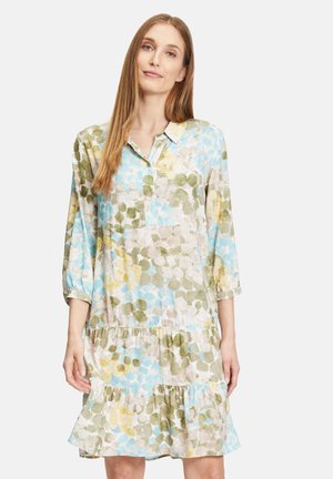 Blumengemustertes Kleid in Blau, Grün und Gelb. Leichter Stoff mit Kragen und Dreiviertelärmeln. Rüschensaum.