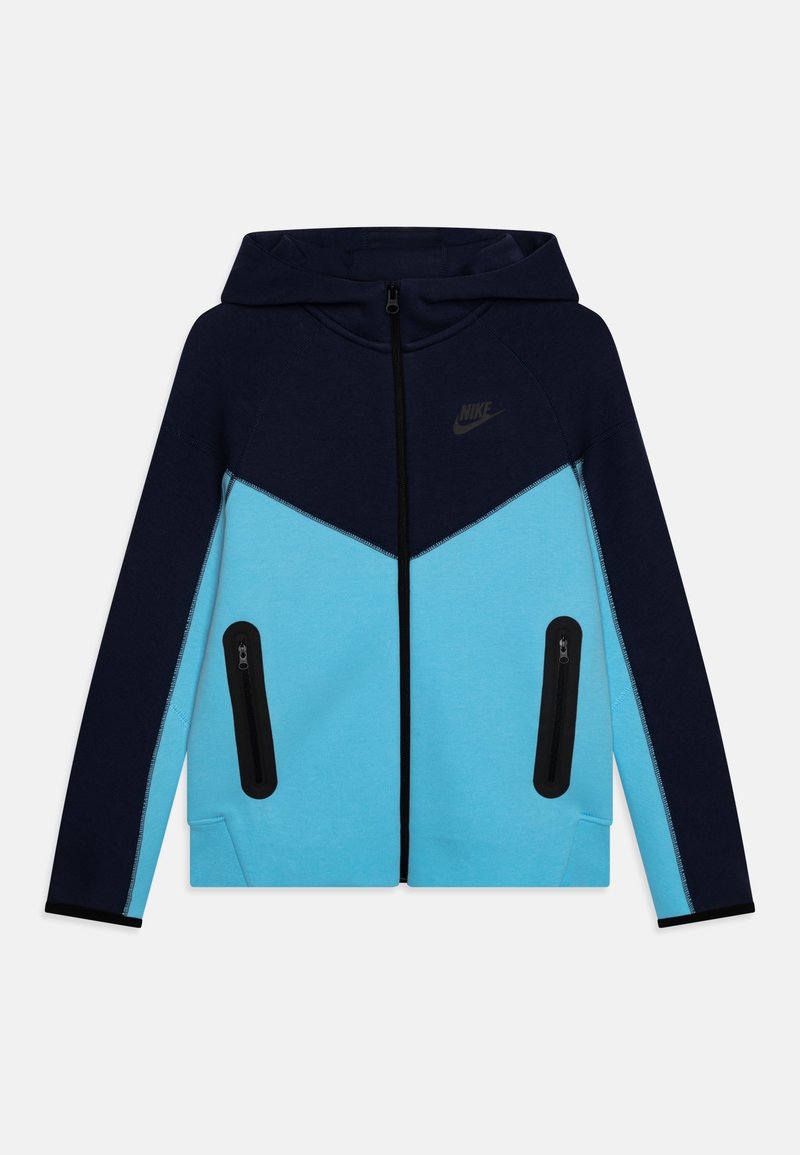 Nike zip-up hoodie i blått och mörkblått, med en chevron-design, två zip-fickor på sidan och svarta detaljer vid ärmar och sömmar.