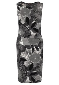 Ärmlös svart och vit knälång klänning med abstrakta cirkulära mönster och bladmönster i varierande nyanser och texturer.