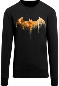 Fekete pulóver, nagy, narancssárga Batman logóval, csöpögő dizájnelemekkel, puha, textúrált anyagból készült. Hosszú ujjú és kerek nyakú.