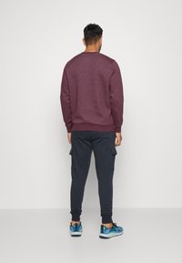 Under Armour RIVAL FLEECE - Træningsbukser - black/white