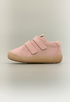 Pink synthetic shoe with two Velcro straps, round toe, rubber sole, and stitching accents. Smooth texture with a minimalistic design.