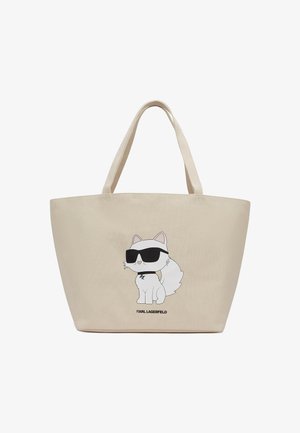 Beige Tragetasche aus Stoff mit einem Cartoon-Katzenmotiv, das eine Sonnenbrille trägt. Verfügt über robuste Griffe und einen gedruckten Markennamen am Boden.