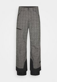 Pantalon de ski gris à motifs avec une poche zippée, des accents noirs aux poignets et une coupe décontractée pour faciliter les mouvements.