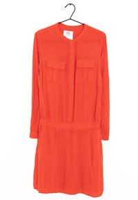 Red button-up dress made of lightweight fabric. Features long sleeves, two chest pockets, and elastic waist for a fitted look.