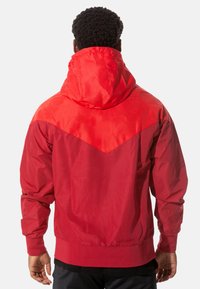 Rot kapuzenjacke mit diagonaler Gestaltung, kontrastierenden Farbtönen, strukturiertem Stoff, elastischen Bündchen und gerafftem Taillenteil.
