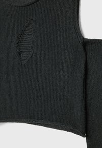 Dark gray knitted fabric with a diamond-shaped cutout detail showing horizontal knit texture underneath.