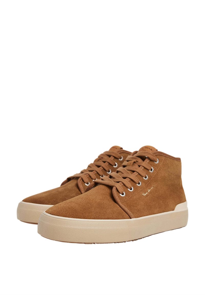 Zapatillas altas de ante marrón con puntera redondeada, suela de goma beige y cordones en tono. Cuenta con un sutil logo en el lado exterior.