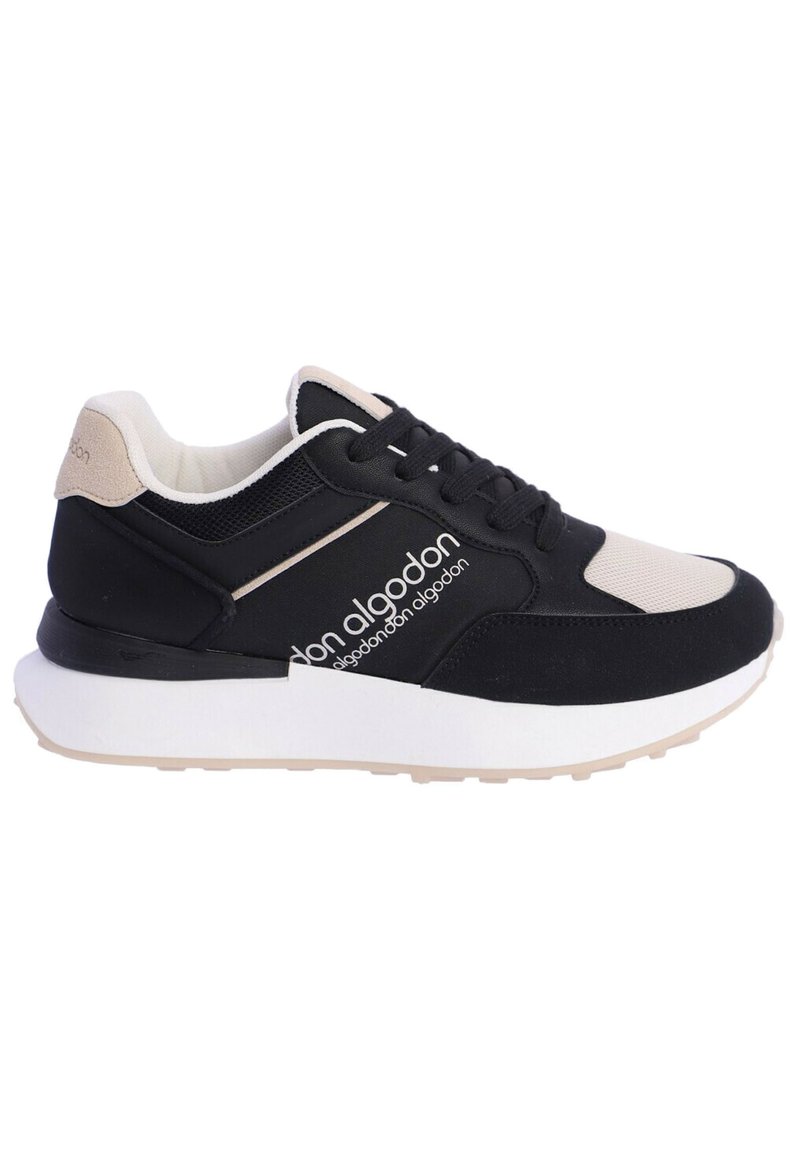Zapatilla negra y beige con materiales de malla y ante, que cuenta con una suela texturizada, entresuela blanca y logo en el costado.