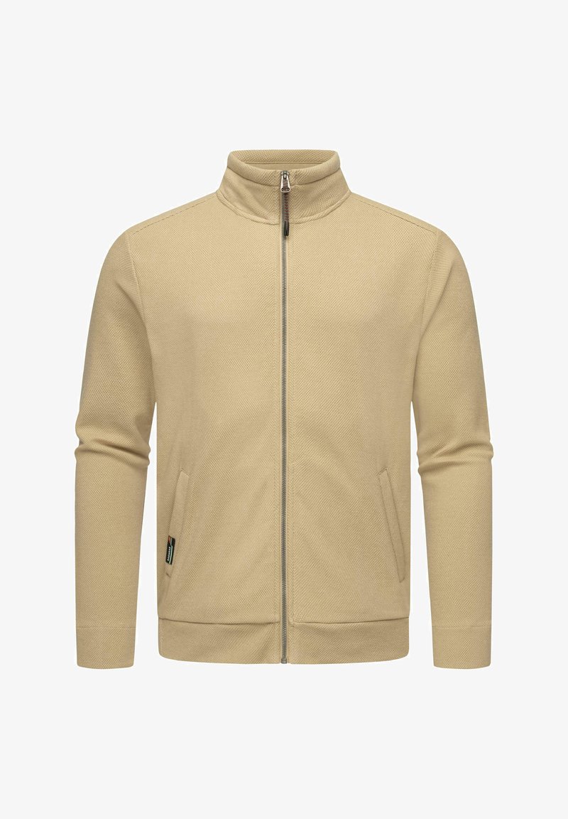 Beige zip-up jacket with a high collar, side pockets, textured fabric, and a fitted design, featuring a silver zipper and minimal branding.