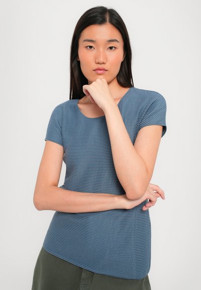 Short-sleeve blue textured top with a round neckline. Material features raised stripes, tailored fit, and a curved hemline.
