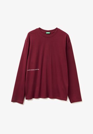 Burgundy long-sleeve t-shirt made of cotton. Features a crew neckline and white text "UNITED COLORS OF BENETTON" on the side. Smooth texture.