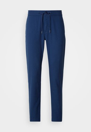 Pantaloni blu navy realizzati in tessuto morbido, con una vita elastica dotata di cordoncino e gambe affusolate. Nessuna tasca visibile.