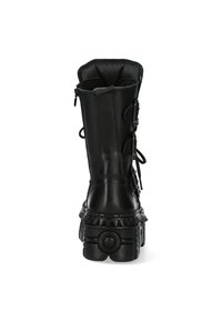 Black leather ankle boot with a chunky sole, zipper closure, and decorative lace accents. Features a padded collar and textured platform.