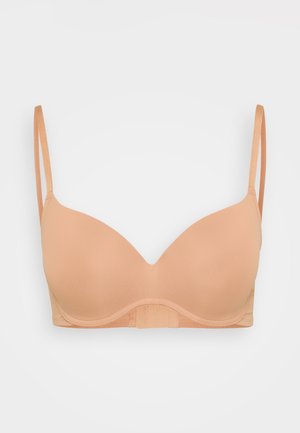 Leicht gepolsterter BH in zartem Pfirsichton. Glattes Material mit verstellbaren dünnen Trägern und nahtlosem Design, ausgestattet mit einem Haken- und Ösenverschluss.