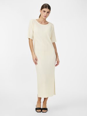 Light beige midi dress with vertical pleats, short sleeves, a round neckline, and a side slit. Smooth texture and minimalist design.