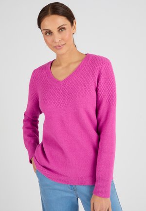 Maglione a V in un vivace rosa, con una lavorazione a maglia strutturata sul petto e maniche lunghe con polsini e orlo a coste.