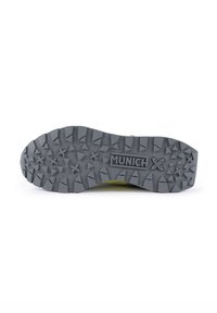 Gray rubber shoe sole with deep treads, featuring a central “MUNICH” logo and a textured pattern for traction.