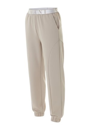 Pantalones jogger beige con cintura elástica con el texto "ARMANI", bolsillos laterales y puños elásticos en los tobillos.
