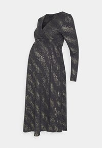 Svart gravidklänning med långa ärmar, insvängd design och guldprickat mönster. Tillverkad av mjukt material med en flödande silhuett.